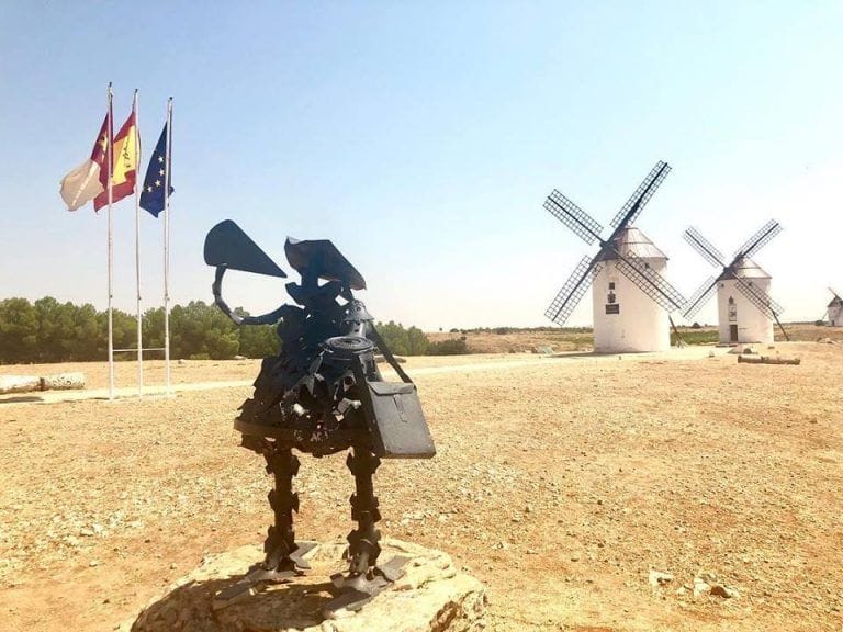 Sancho Panza is drinking wine in the windmills of La Mancha